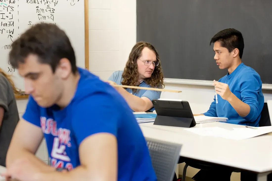 Walter Freeman working with a student in the Physics Lounge.